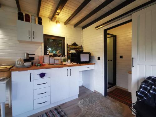 a kitchen with white cabinets and a door to a room at İstanbul Airport Bungalow With Terrace in Arnavutköy
