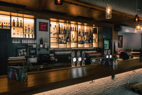 a bar with a lot of bottles of alcohol at B&B Hotel DIE BARBARA in Schladming