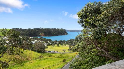 a view of a lake from a hill at Pohutukawa Paradise - Martins Bay Holiday Home in Mullet Point