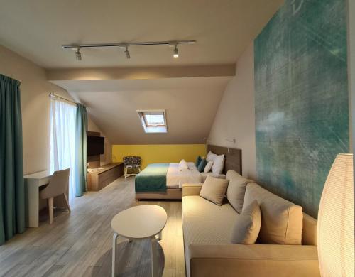 a hotel room with a couch and a bed at Garni Hotel D10 in Belgrade