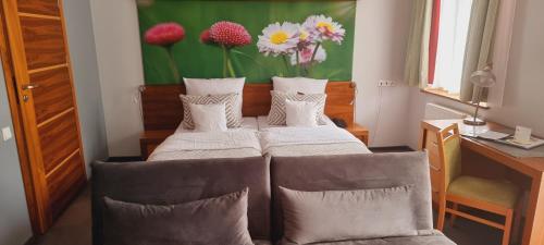 three beds in a room with a desk and a painting at Hotel Szarlota - Kompleksowo na Kaszubach in Kościerzyna