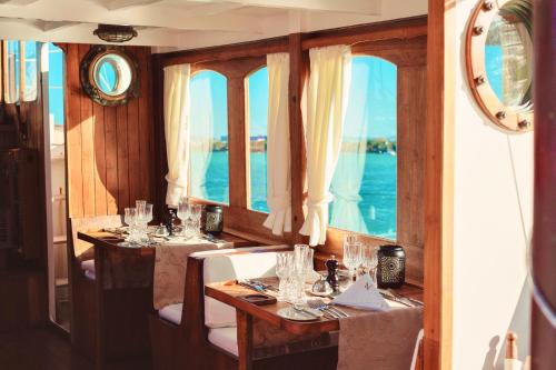 a dining room with two tables with wine glasses at La Maison 20 Degrés Sud - Relais & Châteaux in Grand Baie