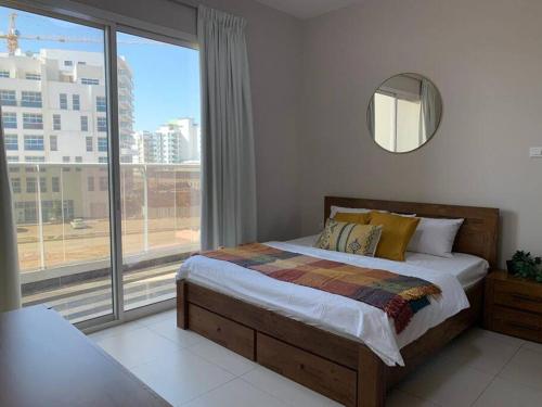 sypialnia z łóżkiem i dużym oknem w obiekcie A Calm&Cozy 1BR-20 MIN-DXB AIRPT w Dubaju