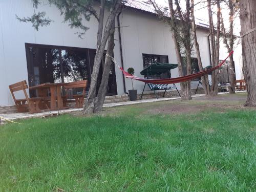 a hammock in a yard next to a house at Тузлата пентхаус / Tuzlata penthouse in Balchik