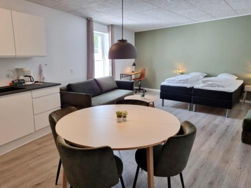 a living room with a table and a bed at Go Sleep Vandel in Vandel