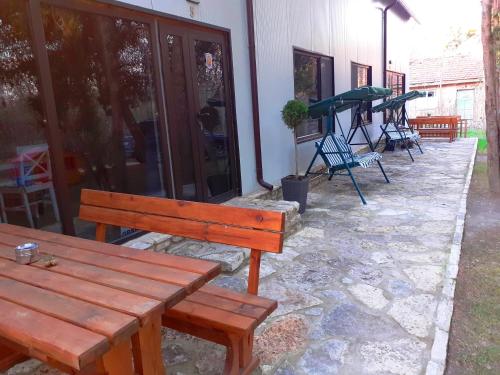 a group of benches sitting outside of a house at Тузлата пентхаус / Tuzlata penthouse in Balchik