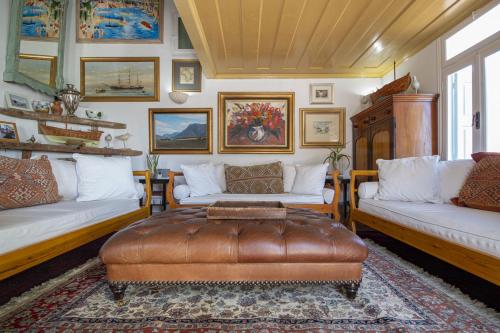 a living room with two couches and a table at Panorama in Symi