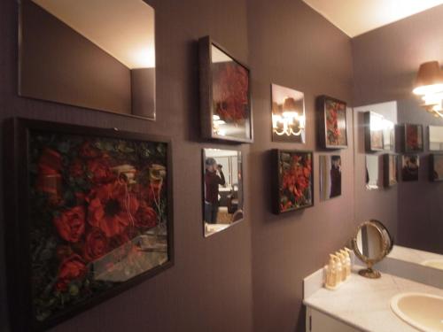 a bathroom with pictures on the wall and a sink at SKYROAD Adult Only in Tokyo