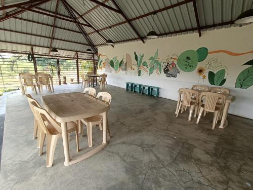 a dining room with a table and chairs at Osaree Agro and Art Hub in Kolhapur