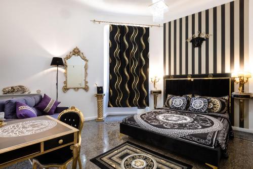 a living room with a bed and a couch at Le Stanze del Principe in Genova
