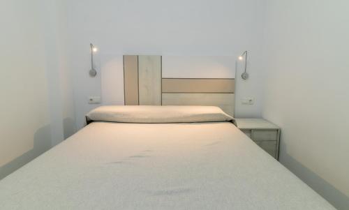 a small bedroom with two beds in it at SAN ANDRÉS 13 in Torre del Mar