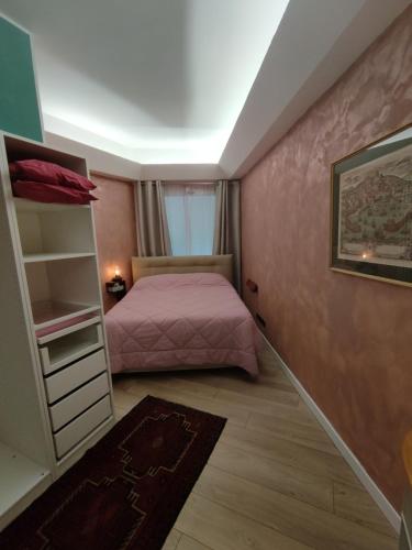 a bedroom with a bed and a book shelf at Gioiellino a Trieste in Trieste