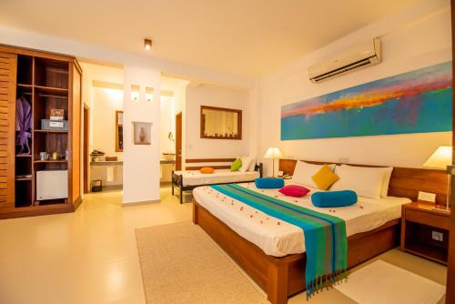a bedroom with two beds in a room at The Residence Hikkaduwa in Hikkaduwa
