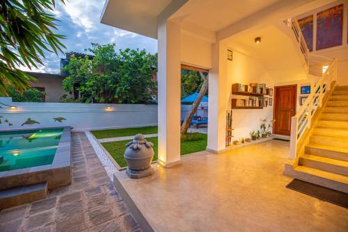 a house with a swimming pool and a staircase at The Residence Hikkaduwa in Hikkaduwa