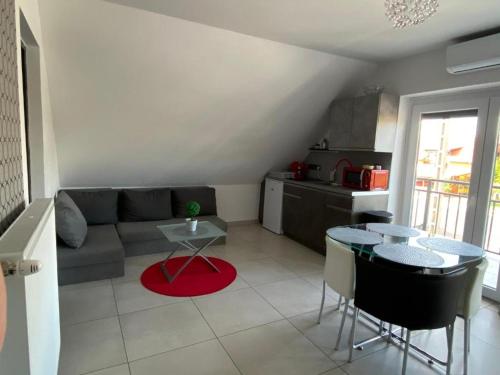 a living room with a couch and a table at Korona Apartman Balatonboglár in Balatonboglár