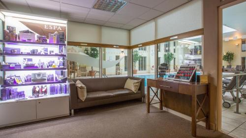 a shop with a couch and a desk in a room at Norton Park Hotel, Spa & Manor House - Winchester in Winchester