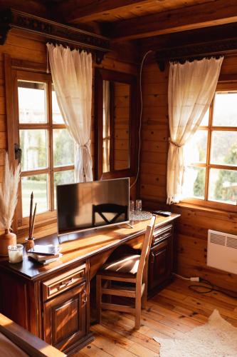 a computer desk in a room with windows at ETNO SELO VRANEŠA Zlatar in Nova Varoš
