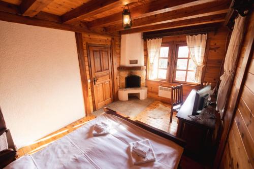 an attic room with a bed and a fireplace at ETNO SELO VRANEŠA Zlatar in Nova Varoš