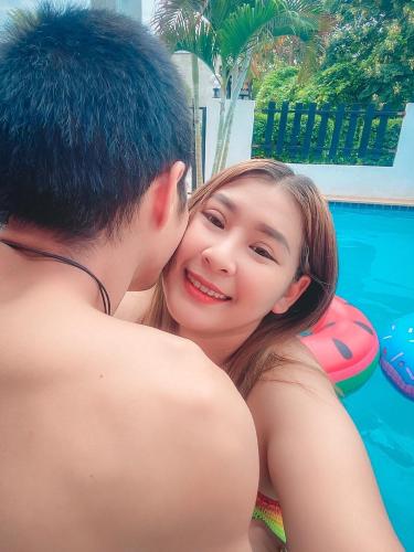 a young man kissing a young woman in front of a pool at Sweet Party Hua-Hin Private Poolvilla From beach 3km in Hua Hin