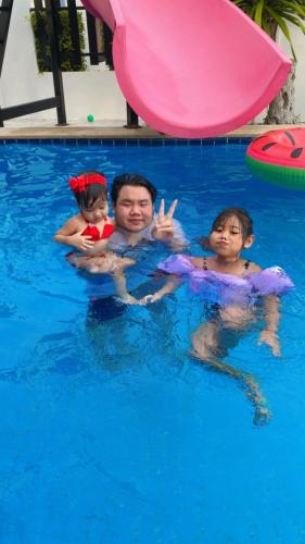 a man and two children in a swimming pool at Sweet Party Hua-Hin Private Poolvilla From beach 3km in Hua Hin