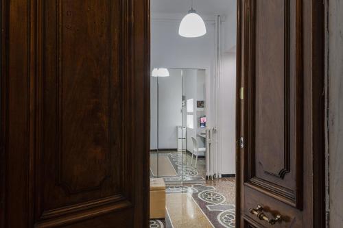 a door leading into a room with a hallway at Natty Family Apartment in Carignano by Wonderful Italy in Genova