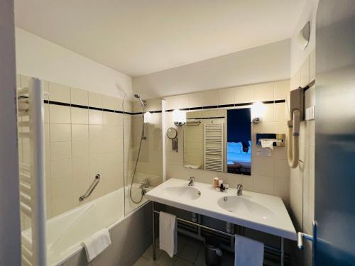 a bathroom with a sink and a shower and a tub at Le Pré Saint Germain in Louviers