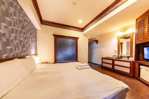 Postel nebo postele na pokoji v ubytování I HI Sanduo Travel Hotel