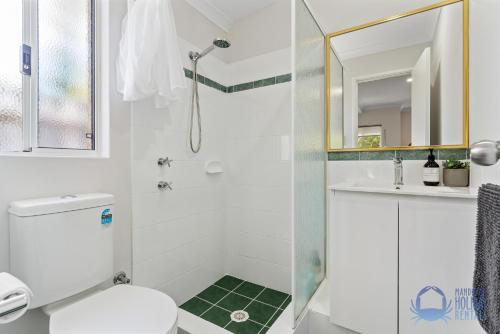 a bathroom with a shower and a toilet and a sink at Halls Head Haven in Mandurah