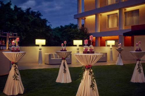 a group of tables in a yard with candles at Hyatt Centric Sector17 Chandigarh in Chandīgarh