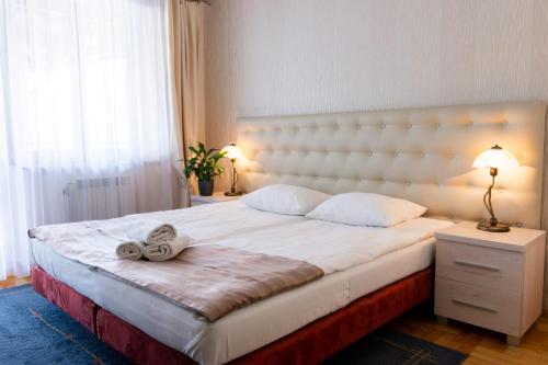 a bedroom with a large bed with a large headboard at Hotel Galicja in Ulanów