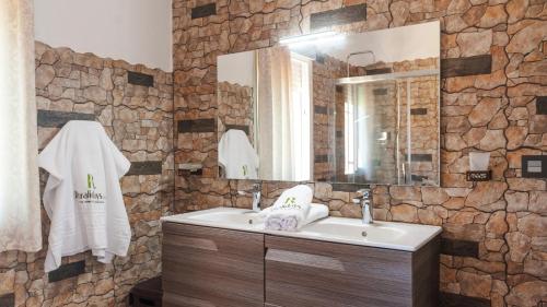 a bathroom with a sink and a stone wall at Villa Ortega Alba Alcalá La Real by Ruralidays in Alcalá la Real