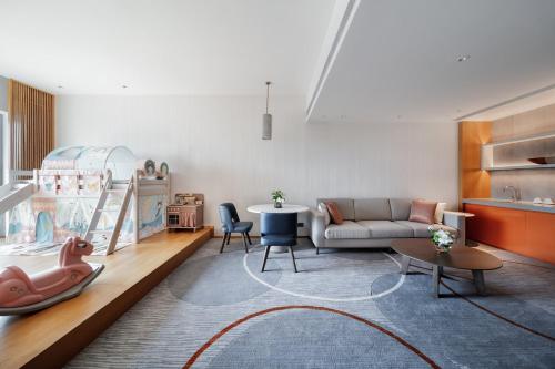 a living room with a couch and a table at InterContinental Suzhou Hotel by IHG in Suzhou