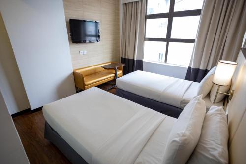Ένα ή περισσότερα κρεβάτια σε δωμάτιο στο Citrus Hotel Johor Bahru by Compass Hospitality