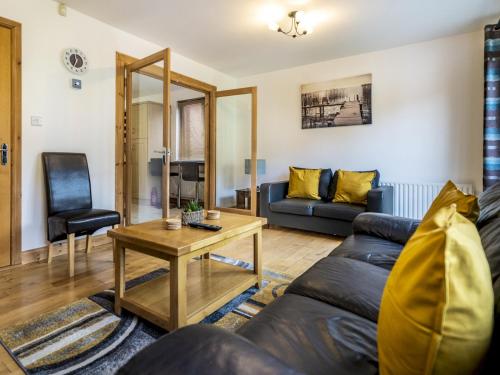 a living room with a couch and a table at Lovely 4BR Home w Garden 7 Min from City Centre - Pass the Keys in Belfast