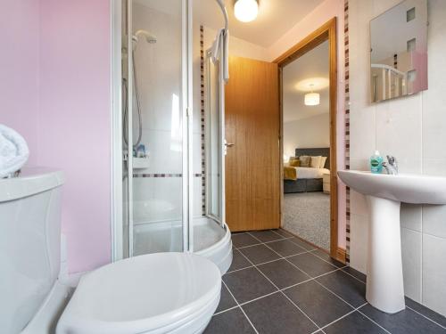 a bathroom with a toilet and a shower and a sink at Lovely 4BR Home w Garden 7 Min from City Centre - Pass the Keys in Belfast