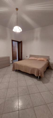 a bedroom with a bed and a light on the ceiling at Niguarda Alfred House in Bresso