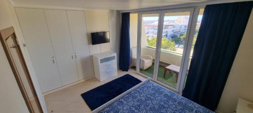 a small room with a bedroom with a balcony at T2+1 - Sousa Vila - Apartament with the best pool @ Algarve in Alvor