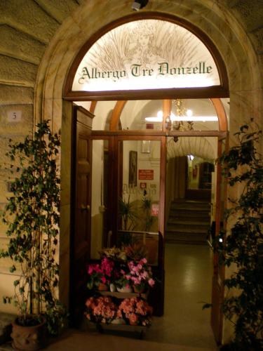 an entrance to a building with flowers in the doorway at Albergo Tre Donzelle in Siena