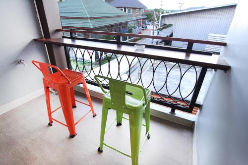 two chairs and a table on a balcony at Avarin Resort in Pak Chong