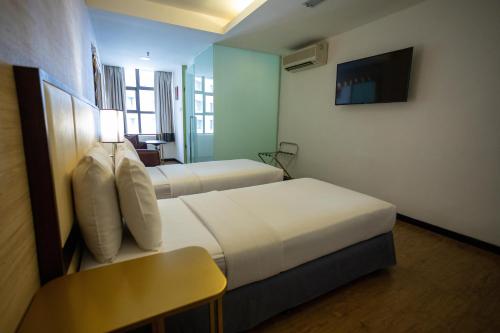 Ένα ή περισσότερα κρεβάτια σε δωμάτιο στο Citrus Hotel Johor Bahru by Compass Hospitality