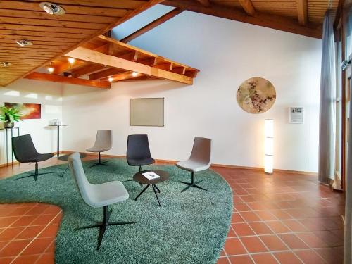 a room with chairs and a table and a screen at Hohenwart Forum in Pforzheim