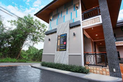 a building with a sign on the side of it at Avarin Resort in Pak Chong