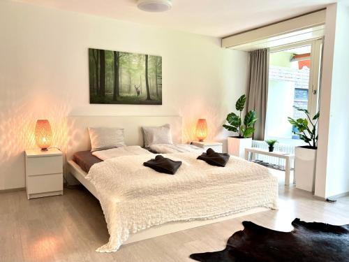 a bedroom with a large bed with two pillows on it at Jutta Deluxe Apartment #325 in Bad Reichenhall