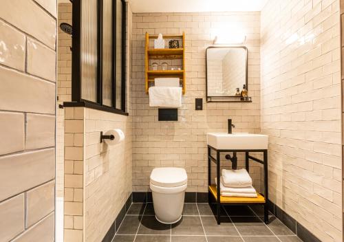 a small bathroom with a toilet and a sink at BrewDog DogHouse Manchester in Manchester