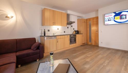 a living room with a couch and a table at ImPuls | aparts in Schladming