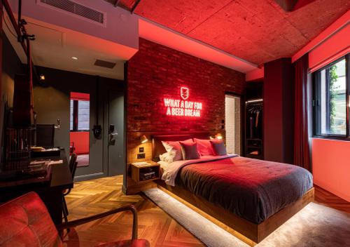 a bedroom with a red brick wall and a bed at BrewDog DogHouse Manchester in Manchester
