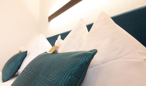 a group of pillows on a bed at ImPuls | aparts in Schladming