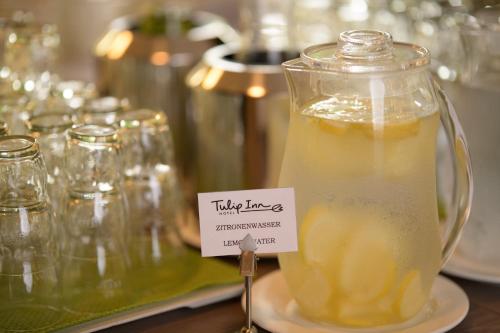a jar of lemon juice on a plate with a tag at Tulip Inn München Messe in Munich