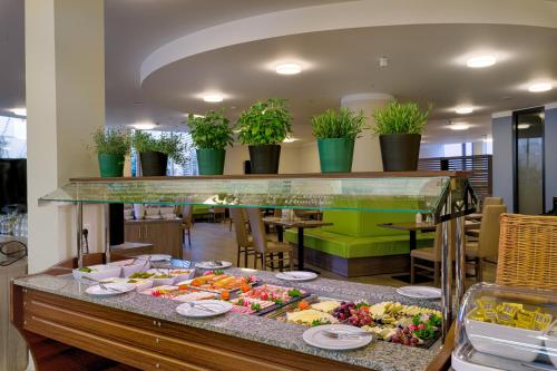 a buffet in a restaurant with a lot of food at Tulip Inn München Messe in Munich