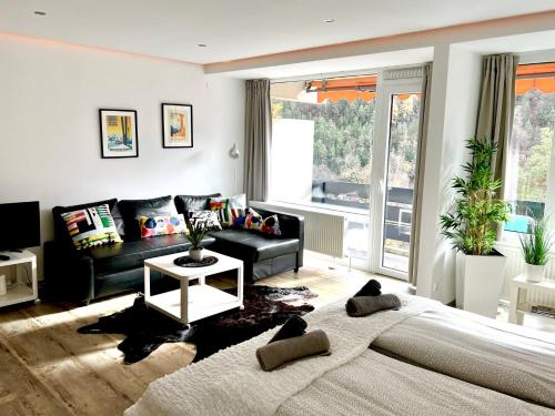 a living room with a bed and a couch at Jutta Deluxe Appartement in Bad Reichenhall